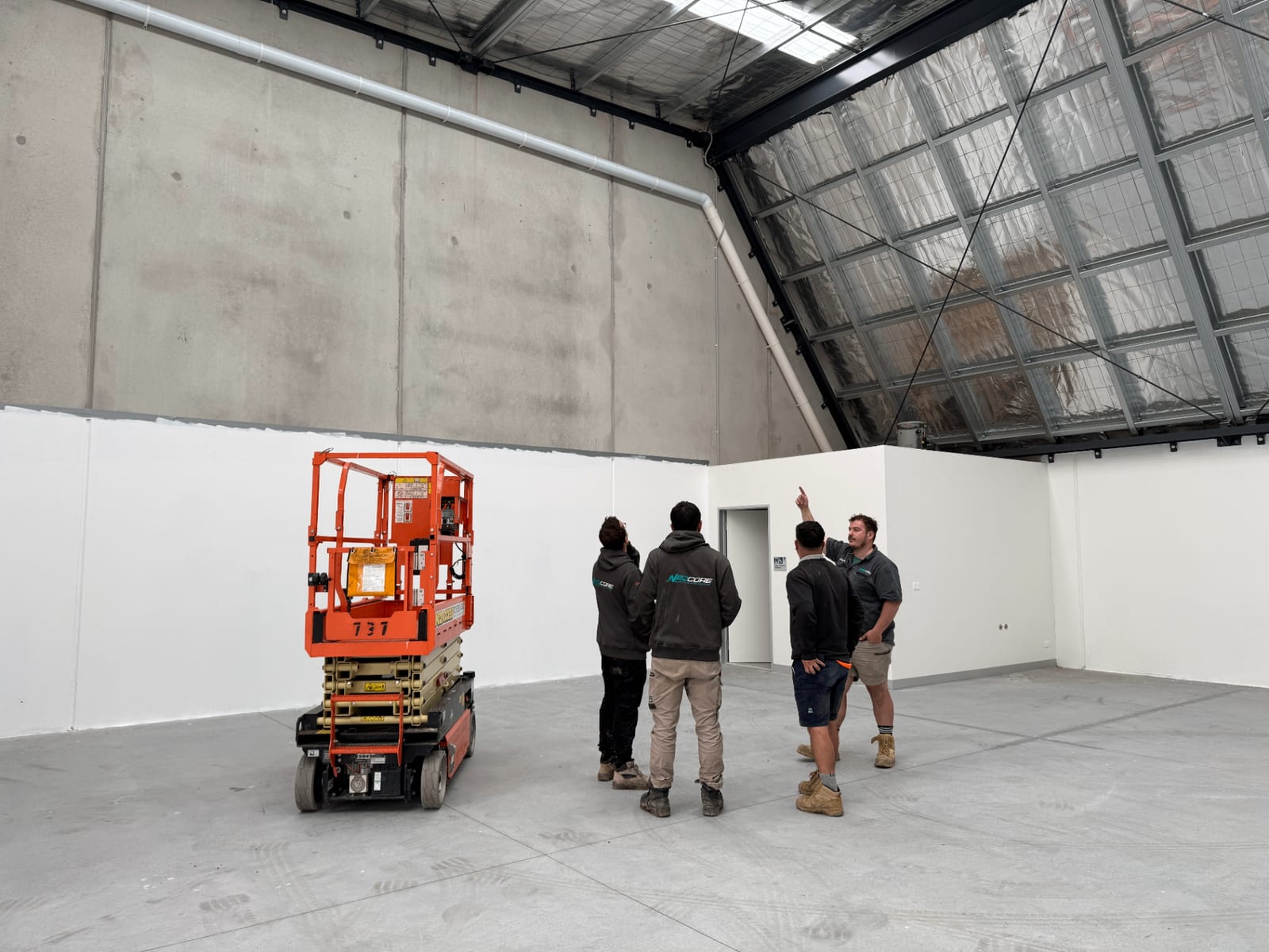 Neocore team planning a commercial electrical fit-out in a Melbourne warehouse