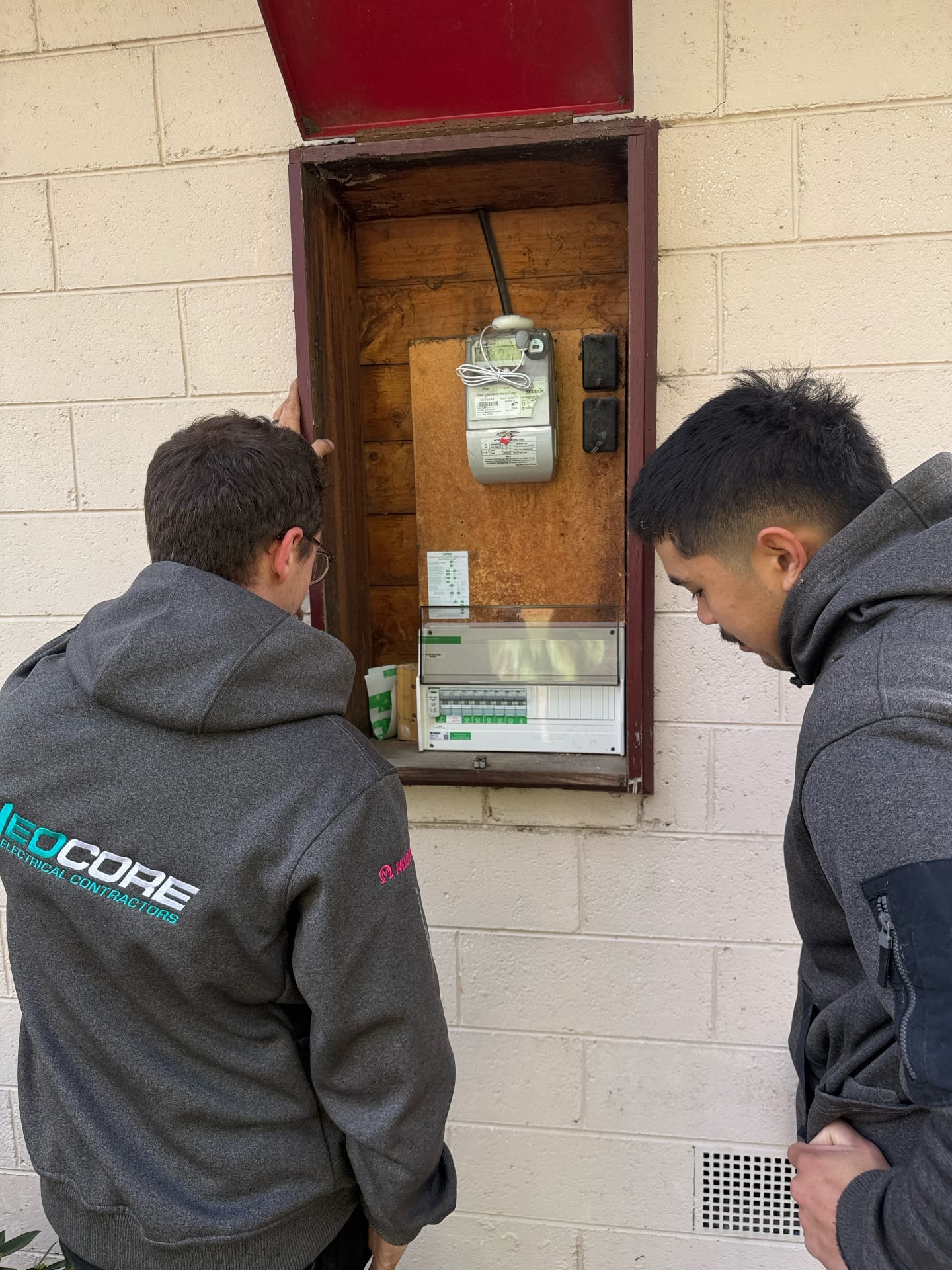Neocore electricians inspecting a switchboard and meter box in Melbourne